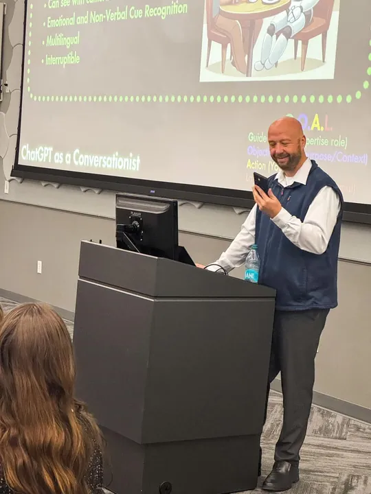 Stoni Beauchamp giving a live AI demonstration using a phone.